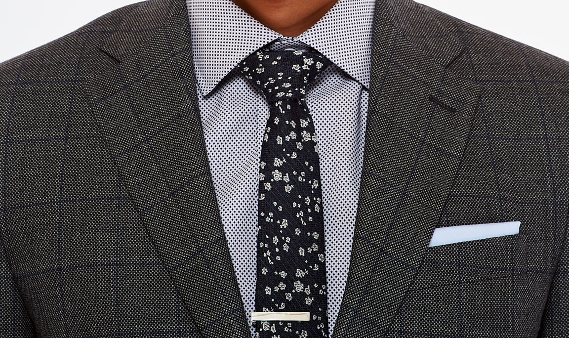 Master patterns with a bold tie and windowpane suit.